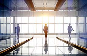 silhouette of a businesswoman walking into the light